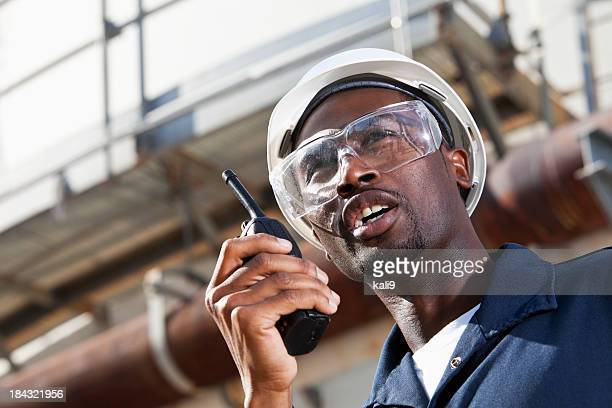 African American man, 20s, working at manufacturing plant.